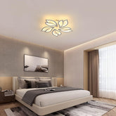 Modern bedroom with a ceiling light fixture, bed, and wall art.